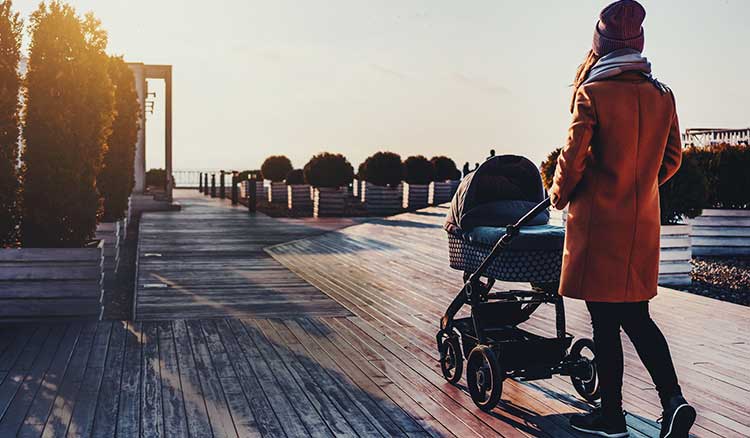 Mom Walking On Dock With Stroller